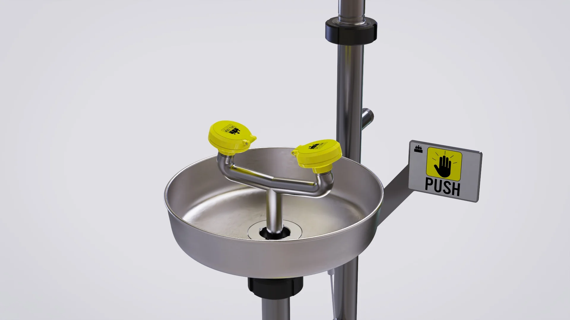 Close-up view of the twin-nozzle eyewash basin and push control.