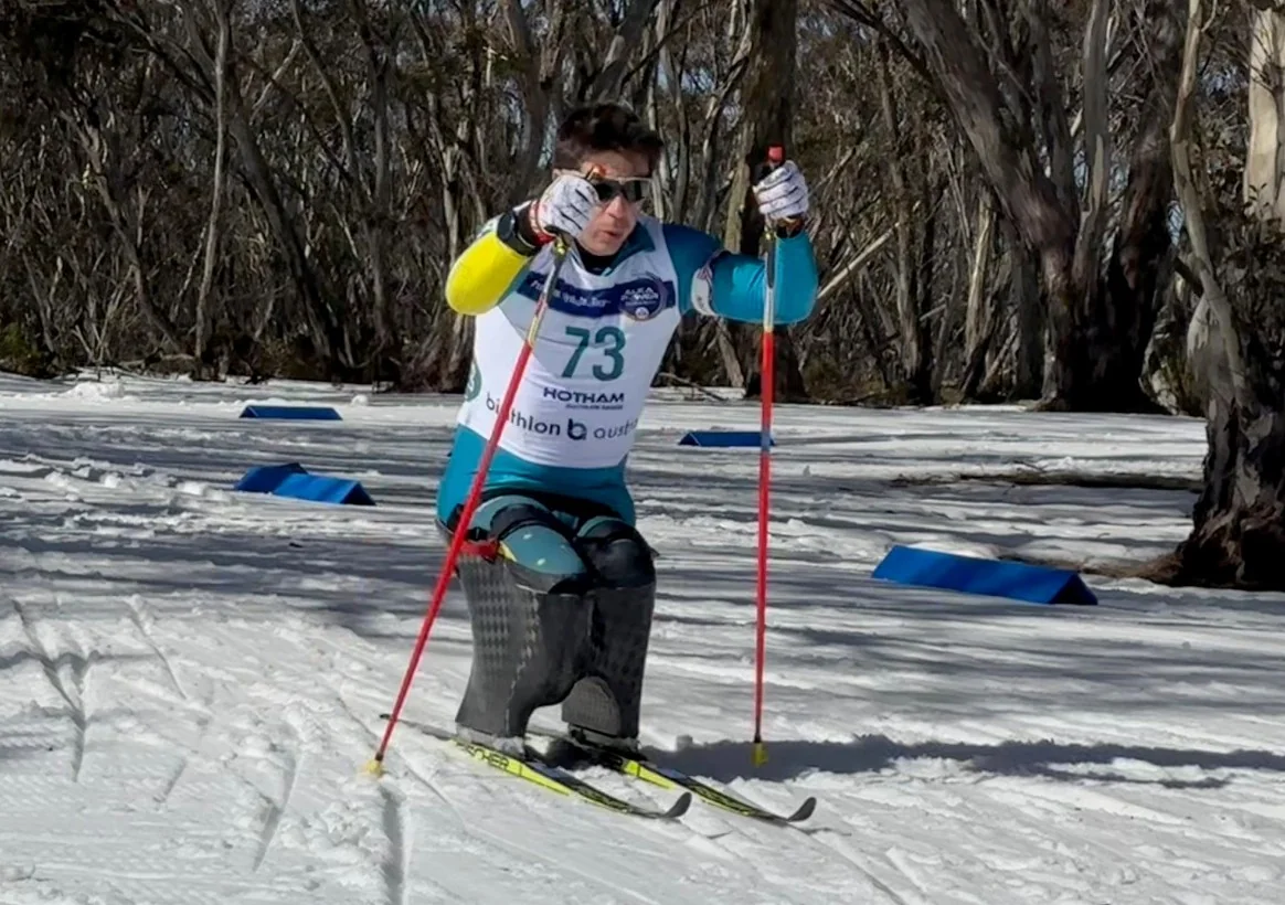 Adaptive athlete photographed skiing in a competition setting.