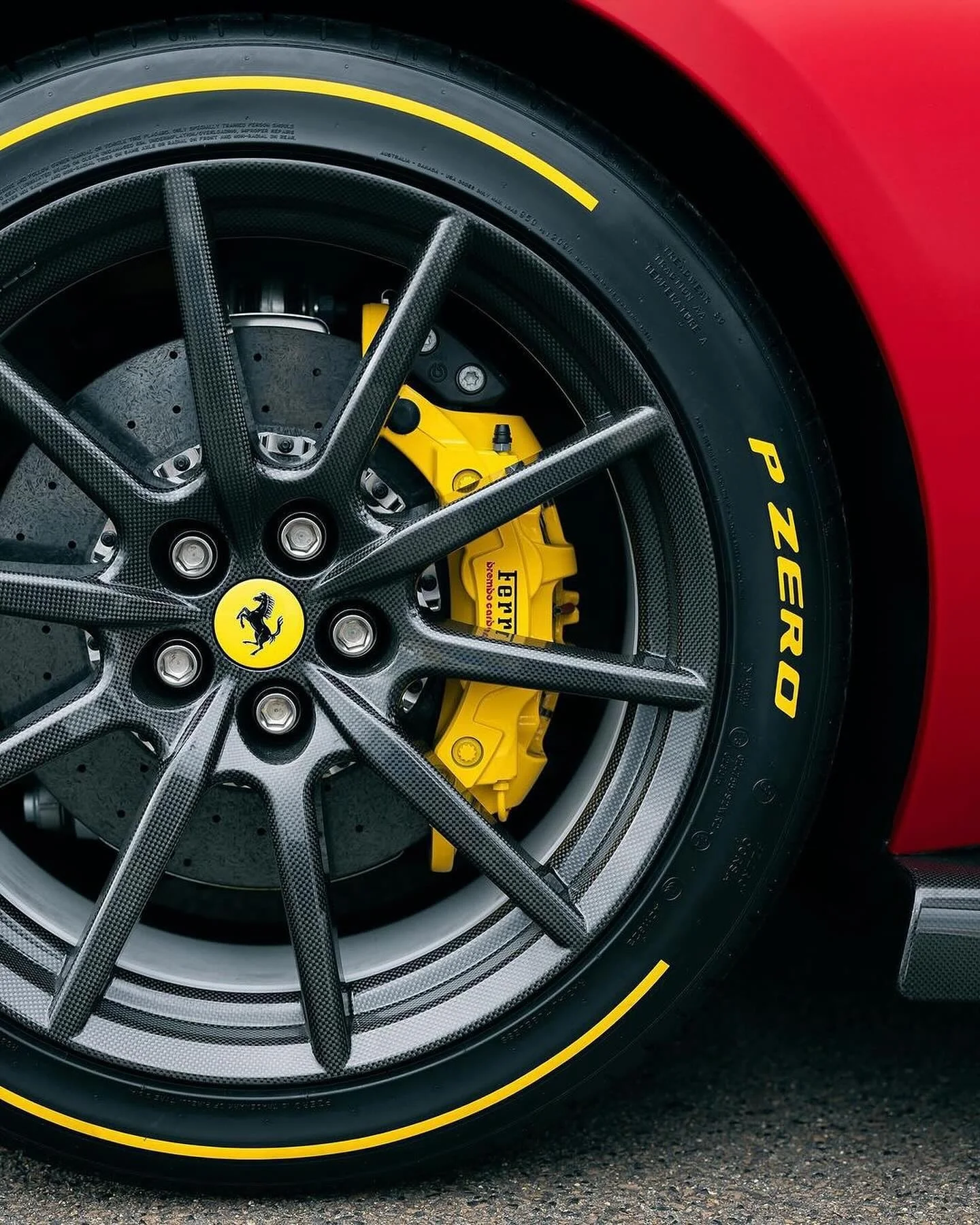 Close study of a carbon-fibre wheel, performance brake and tyre.